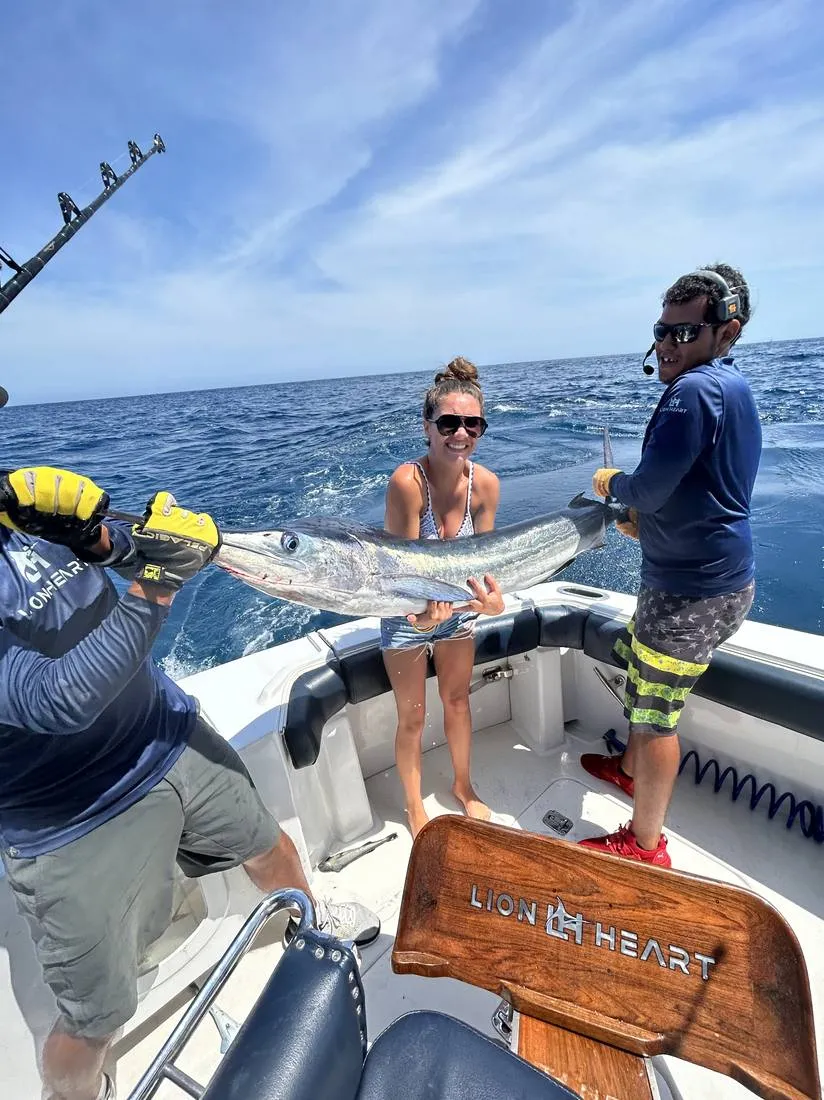 Guest with barracuda catch on offshore fishing trip Lion Heart Cabo San Lucas