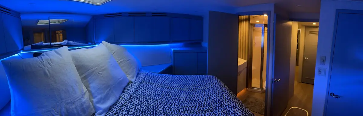 Blue ambient lighting, ensuite head, and companionway